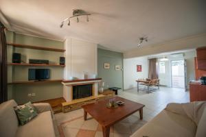 a living room with a couch and a fireplace at Marias BBQ Garden House in Kalamata