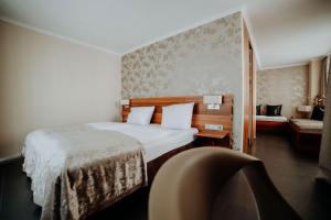 Postel nebo postele na pokoji v ubytování Hotel Ars Vivendi München