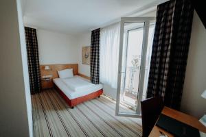 Postel nebo postele na pokoji v ubytování Hotel Ars Vivendi München