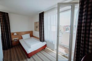 Postel nebo postele na pokoji v ubytování Hotel Ars Vivendi München