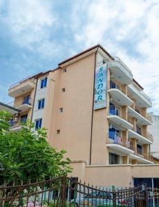 a building with a sign on the side of it at Sandor Hotel in Nesebar