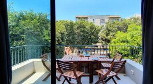 a table and chairs on a balcony with a view at BnBIsrael apartments - Dizengoff Brique in Tel Aviv