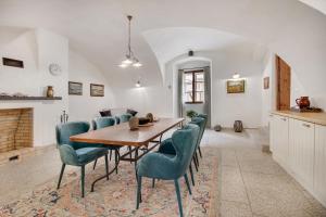 a dining room with a wooden table and chairs at Apartmány Šupina in Třeboň