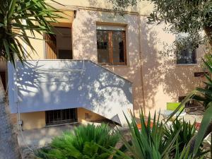 a house with a staircase in front of it at Algherooms in Alghero