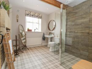 a bathroom with a shower and a toilet and a sink at Cuthbert Hill Farm in Preston +44 photos