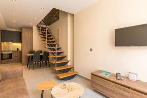 a living room with a spiral staircase and a table at Urban Lofts in Corfu Town