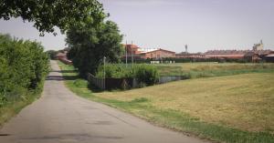 a walking path next to a field with buildings at Parade Allure in Zhashkiv