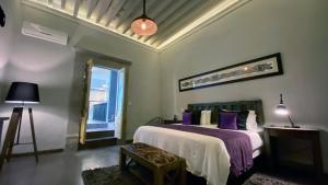 Una cama o camas en una habitación de Casa Brunella - Hotel Boutique Querétaro