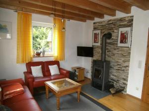 a living room with a couch and a fireplace at Ferienhaus Kettler I in Muhr amSee