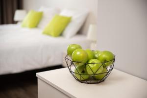 a basket of green apples on a table in a bedroom at U11 Hotel & SPA in Tallinn