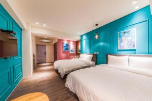 Rúm í herbergi á Talent Hotel