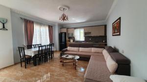 a living room with a couch and a table at Villa Denis Ksamil in Ksamil