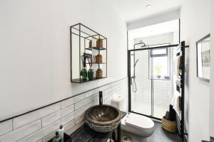 a bathroom with a bowl sink and a toilet at South Shores Cottage Flat in Troon