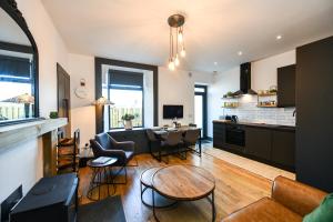 a kitchen and living room with a table and chairs at South Shores Cottage Flat in Troon