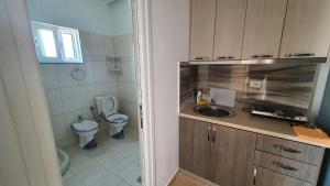 a small bathroom with a toilet and a sink at Villa Denis Ksamil in Ksamil