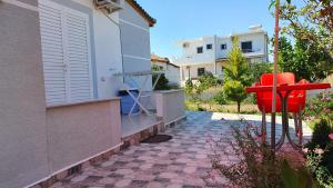 a red object sits outside of a house at Villa Denis Ksamil in Ksamil