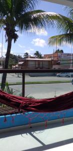 a hammock on a tennis court with a palm tree at Pousada Morada Azul in Porto De Galinhas