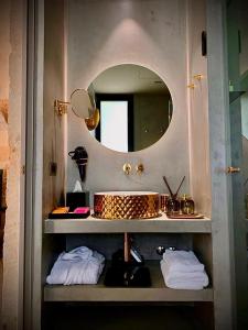 a bathroom with a sink and a mirror at Masseria Li Reni in Manduria