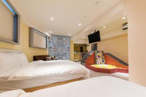 Rúm í herbergi á Talent Hotel