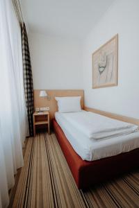 Postel nebo postele na pokoji v ubytování Hotel Ars Vivendi München