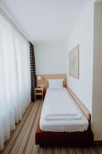 Postel nebo postele na pokoji v ubytování Hotel Ars Vivendi München