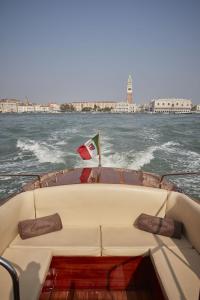 a boat with a santa hat on the water at Hotel Cipriani, A Belmond Hotel, Venice in Venice