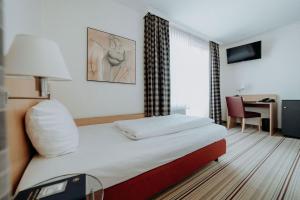 Postel nebo postele na pokoji v ubytování Hotel Ars Vivendi München