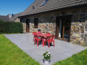 a red table and chairs on a patio at Happy Together in Francorchamps