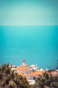 a city with a lighthouse in the middle of the ocean at Charm Nature in Azoia
