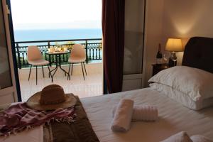 a bedroom with a bed with a view of a balcony at Sofia Apartments in Koroni