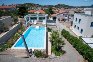 an overhead view of a swimming pool on top of a house at Apartment Summer dreams 2 in Murter