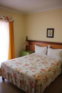Uma cama ou camas num quarto em Residencial Joao Capela