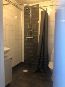 a bathroom with a shower with a shower curtain at Mormors vrå in Mora