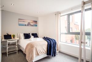 a bedroom with a bed and a desk and a window at Stylish City 2 Bed, 2 Bath, FREE PARKING & WiFi in Sheffield