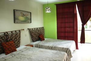 Cama o camas de una habitación en Hotel Cascada Huasteca