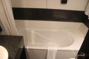 a white bath tub in a bathroom with a counter at Hotel Ordem De Santiago in Alcácer do Sal +138 photos