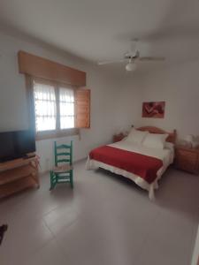 una camera con letto, sedia e televisore di Casa Mudéjar Alicún a Alicún