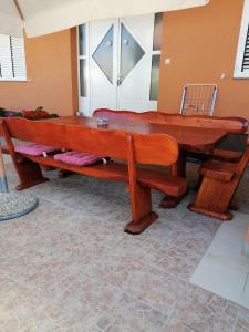 a large wooden bench sitting in a room at Apartments Perla in Biograd na Moru