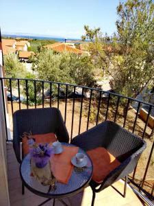 een tafel en stoelen op een balkon met uitzicht bij Studio apartman Erika in Ližnjan