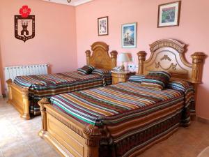 Hotel Flor de la Mancha tesisinde bir odada yatak veya yataklar