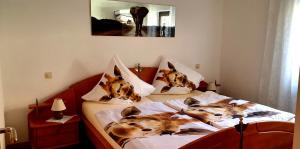 two dogs on pillows on a bed in a bedroom at Karibu in Tiefenthal