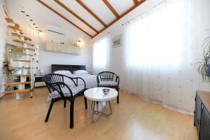 a bedroom with a bed and a table and chairs at Puntamika studio in Zadar