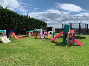 a group of playground equipment in a grass field at The Gatehouse in Upwell