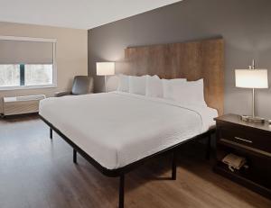 a bedroom with a large bed and a chair at Extended Stay America Suites - Washington, DC - Alexandria - Landmark in Alexandria +39 photos
