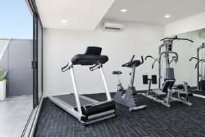 a gym with several tread machines in a room at Punthill Oakleigh in Oakleigh