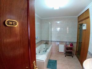 a bathroom with a bath tub and a sink at Laredo Ocean Port in Laredo +25 photos