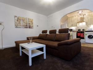 a living room with a couch and a table at Shaftesbury Apartment in Leeds