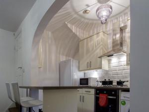 a kitchen with a table and a chandelier at Shaftesbury Apartment in Leeds