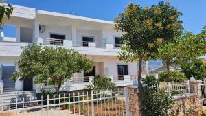 a white building with trees in front of it at Villa Soni Oruci in Ksamil