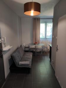 een woonkamer met een bank en een tafel bij Heliosa Apart Gdańsk Kowale in Gdańsk